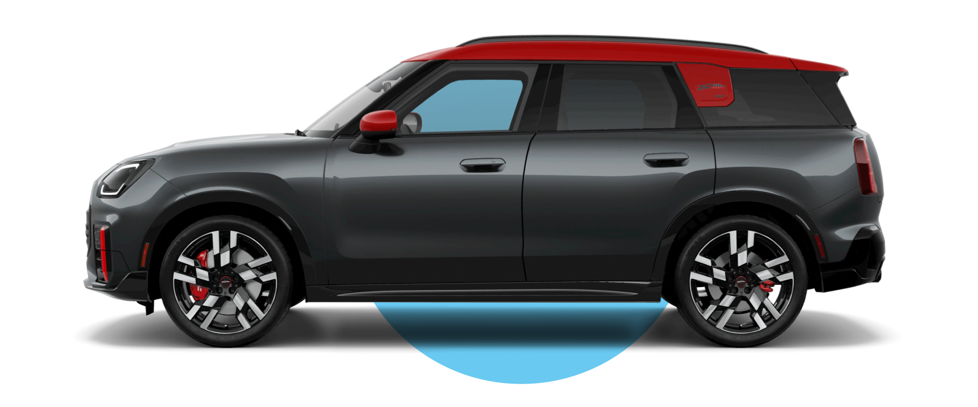 Vista lateral de un MINI JCW Countryman ALL4 en el color de carrocería Gris Leyenda, mirando hacia la izquierda con su sombra debajo.