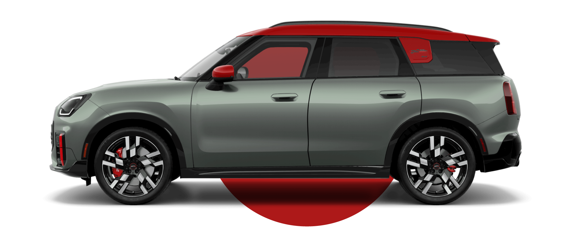 Vista lateral de un MINI JCW Countryman ALL4 en el color de carrocería Smokey Green, mirando hacia la izquierda con su sombra debajo.